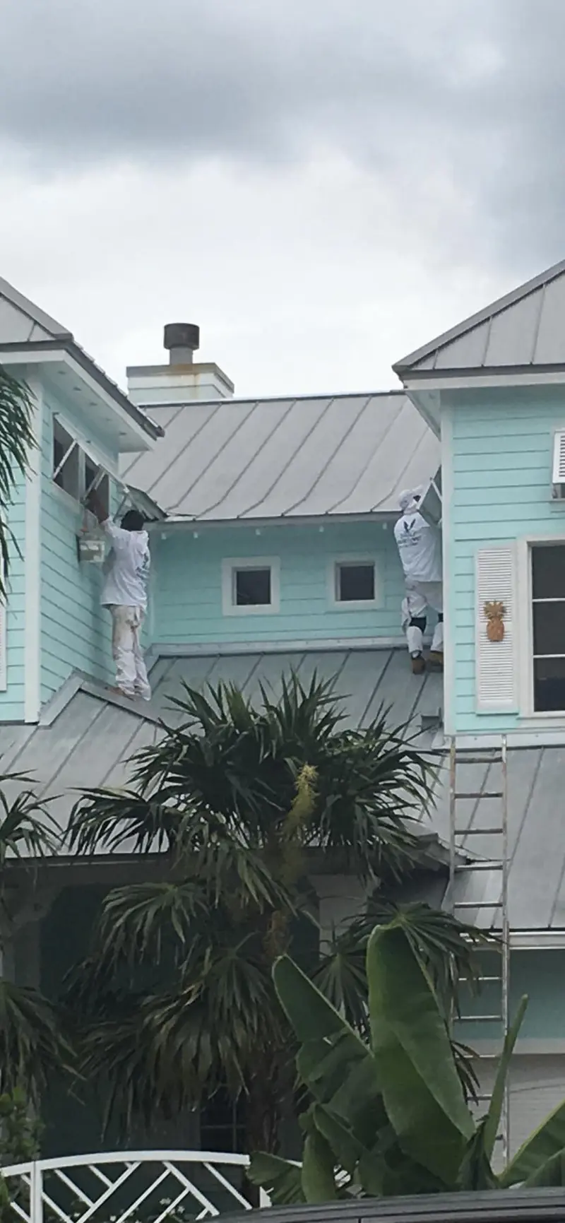 Eagle Painting crew repainting the exterior of a two-story home in Sunrise, Florida
