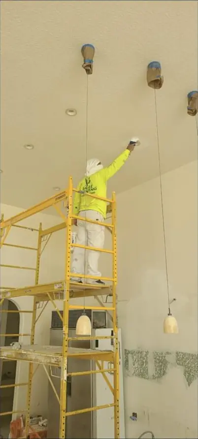 Scaffold work on a two-story foyer ceiling in a Broward home