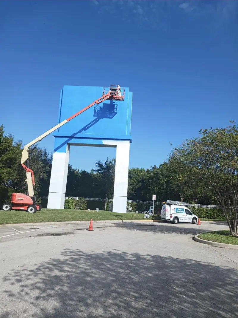 Eagle Painting boom lift at a tall sign structure in Sunrise, Florida