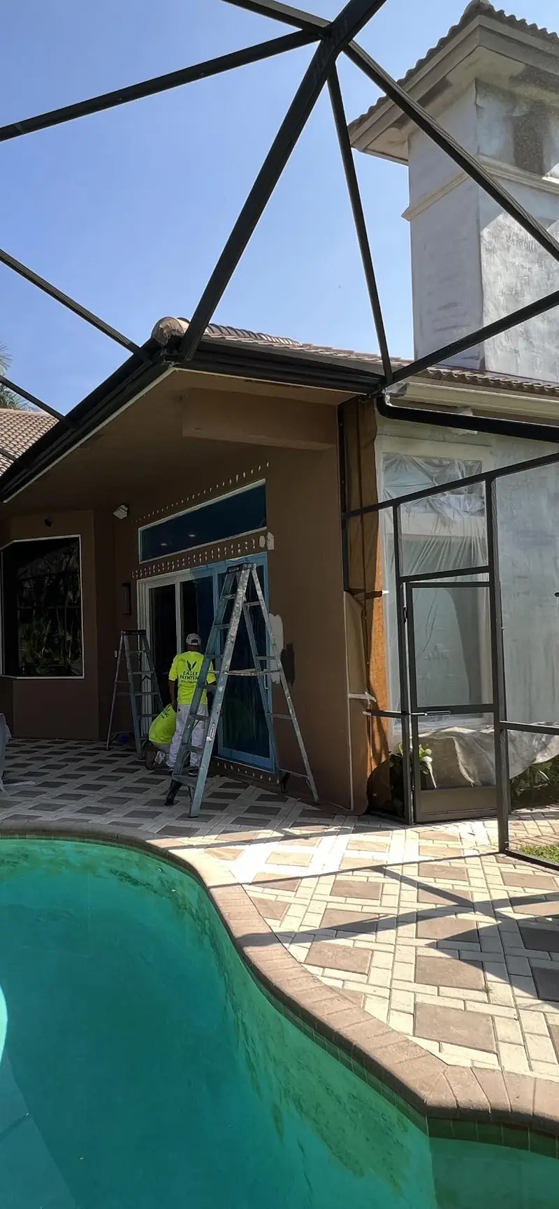 Pool screen enclosure and lanai being repainted at a Broward home
