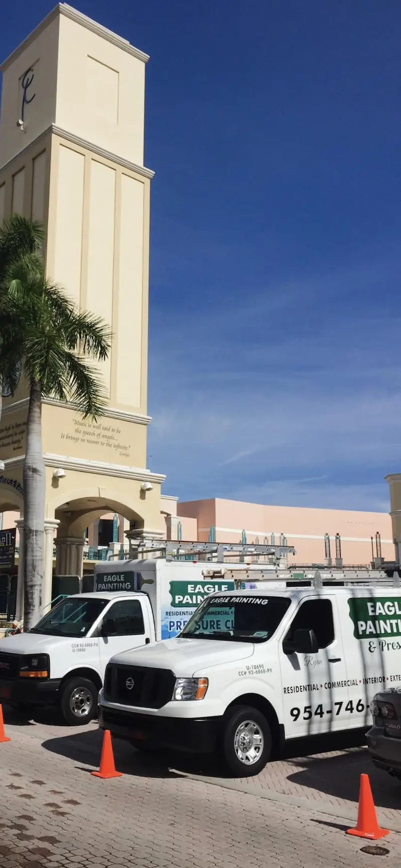Eagle Painting truck at a shopping plaza clock tower during an exterior repaint