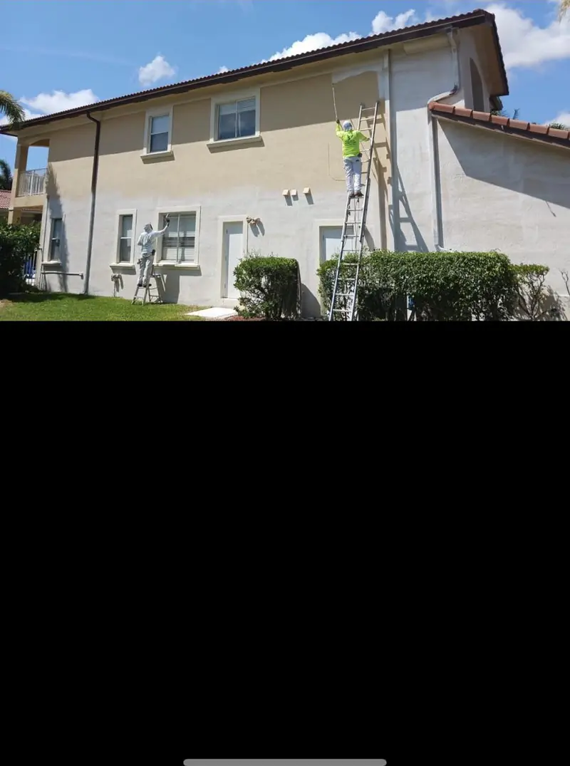 Stucco home exterior mid-repaint