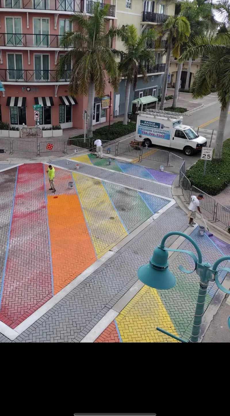 Eagle Painting crew repainting the rainbow crosswalk in Wilton Manors
